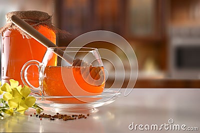 Glass jars with honey on white kitchen table front view Stock Photo