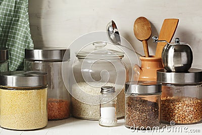 Glass jars with legumes, groats and useful seeds. Healthy vegetarian food. Stock Photo