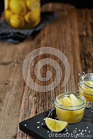 Glass jars with lemon pieces in salt Stock Photo