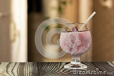 A glass of juice covered in icy sweat is prepared to beat the heat Stock Photo