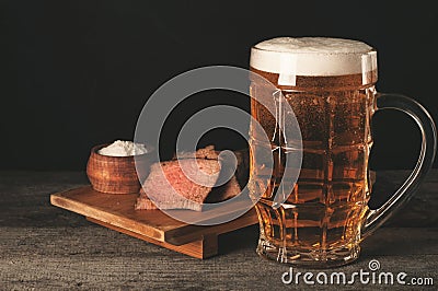 Glass of light foam beer with meat appetizer Stock Photo