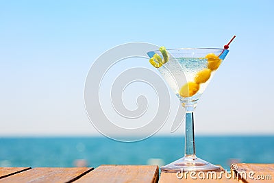 Glass of martini bianco at the wooden pier. Concept of summer va Stock Photo