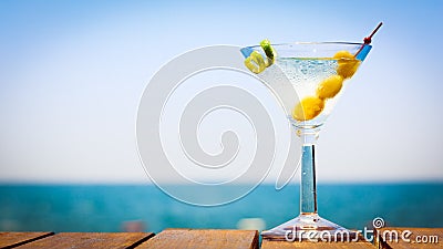 Glass of martini bianco at the wooden pier. Concept of summer va Stock Photo