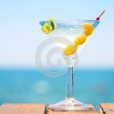 Glass of martini bianco at the wooden pier. Concept of summer va Stock Photo