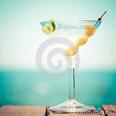 Glass of martini bianco at the wooden pier. Concept of summer va Stock Photo