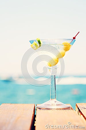 Glass of martini bianco at the wooden pier. Concept of summer va Stock Photo