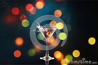 Martini in glass with olives on bokeh background Stock Photo