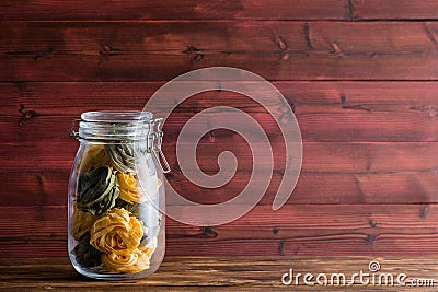 Glass masons jar filled with fettuccine pasta Stock Photo