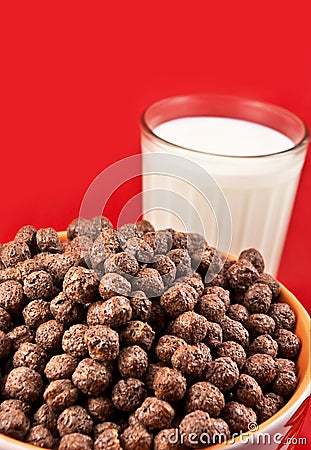Glass with milk and chokolate balls Stock Photo