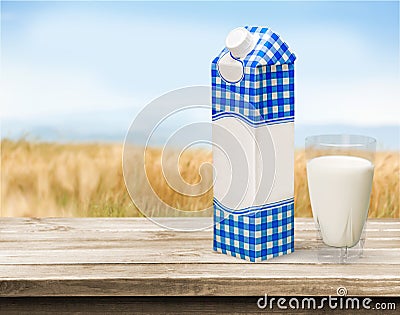Glass of milk and package on wooden background Stock Photo