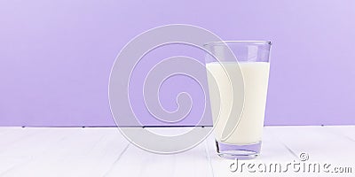 Glass milk with puprle background Stock Photo