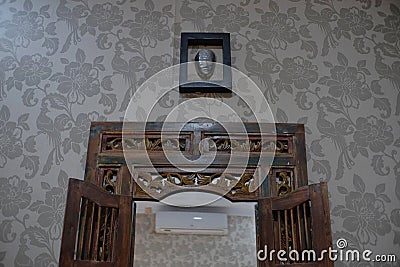 Glass mirror with a classic carved wooden frame shaped like a window Stock Photo