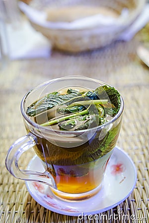 A glass of Moroccan mint tea placed on the dining table Stock Photo