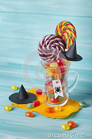 Glass mug filled with assorted Halloween candy Stock Photo