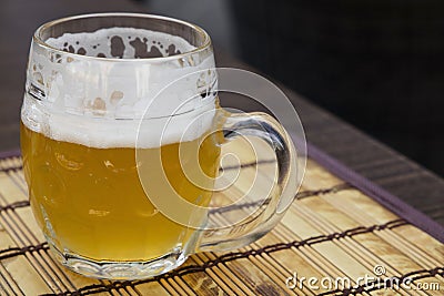 Glass mug of unfiltered weizen beer on table Stock Photo