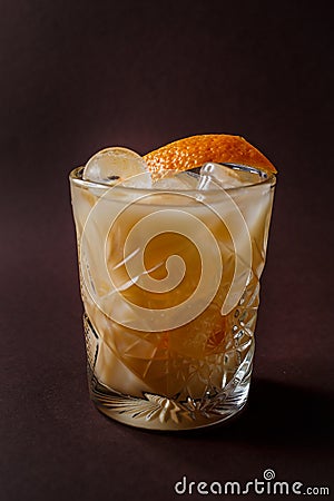 Glass of orange alcohol cocktail with ice and slice of orange on Stock Photo