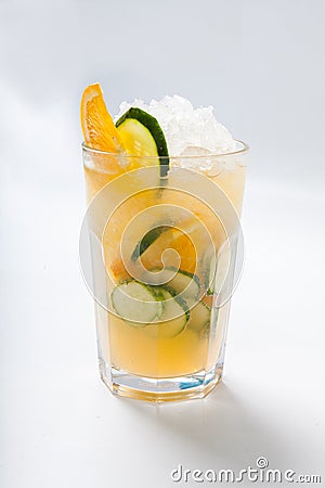 Glass with orange cucumber refreshing drink, rustic style, selective focus Stock Photo