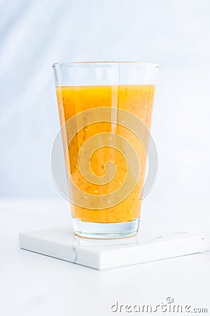 Glass of orange fruit smoothie juice with chia seeds for diet detox, perfect breakfast recipe Stock Photo