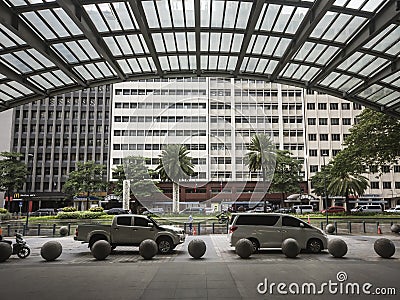 A glass overhang frames a row of buildings on the opposite side. Editorial Stock Photo