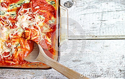 Glass Pan Full Of Cooked Stuffed Shells With Wooden Spoon Stock Photo