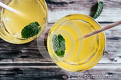 Glass of peach syrup with water and fresh mint - Refreshing drink Stock Photo