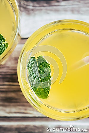 Glass of peach syrup with water and fresh mint - Refreshing drink Stock Photo