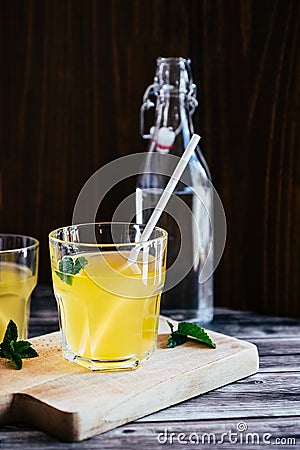 Glass of peach syrup with water and fresh mint - Refreshing drink Stock Photo