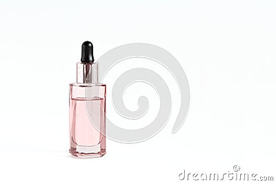 Glass pink bottle with a pipette with face serum on a white background Stock Photo