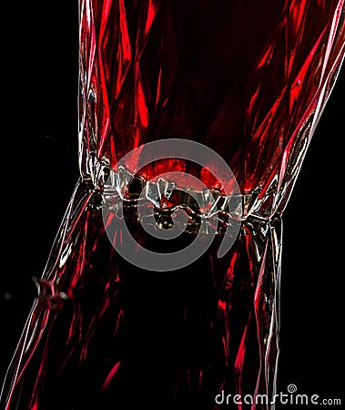A glass with red drink on a dark background. Stock Photo