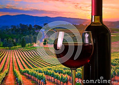 Glass with red wine and bottle, atmosphere sunset Stock Photo