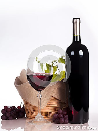 Glass of red wine, bottle and grapes isolated. Alcohol drinks, vine and wineglass on white clean background. Generative AI Stock Photo