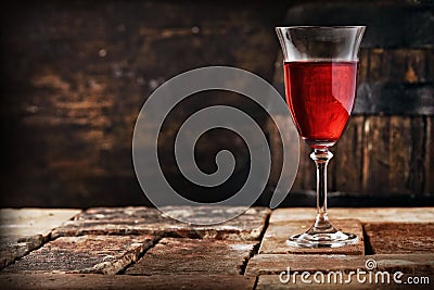 A glass of red wine on an old rustic table Stock Photo