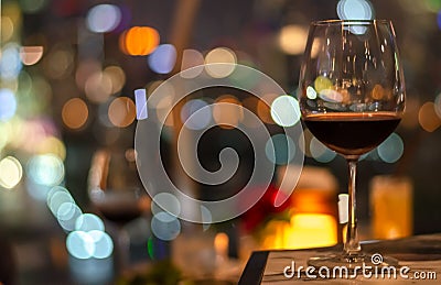 A glass of red wine on table of rooftop bar Stock Photo