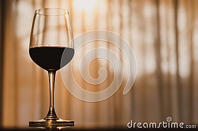A glass of red wine on table in the room Stock Photo