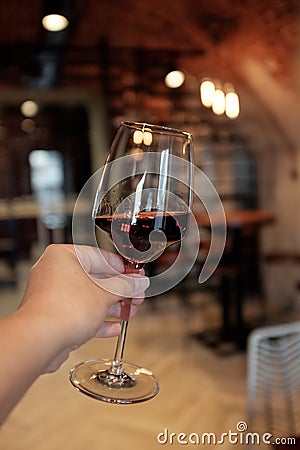 A glass of red wine in a woman`s hand Stock Photo