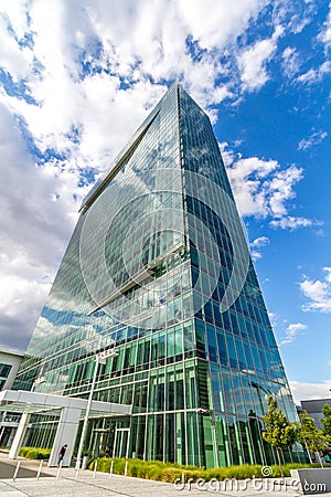 Glass reflective office buildings against blue sky with clouds and sun light Stock Photo