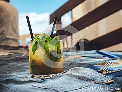 Glass of refreshing cold mango mojito on the table Stock Photo