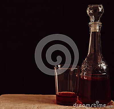 Glass retro decanter and glass on table with red drink Stock Photo