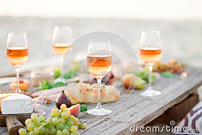 Glass of rose wine on picnic table. Stock Photo