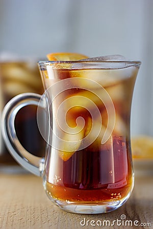 Glass of rum and cola with the ice cubes and slice of orange. Stock Photo