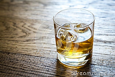 Glass of rum on the wooden background Stock Photo