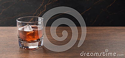 Glass of scotch whiskey and ice. Whisky, bourbon, brandy or rum on wooden table. Stock Photo