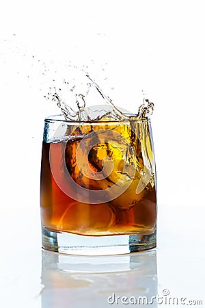 Glass of scotch whiskey and ice on a white background Stock Photo