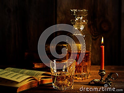 Scotch Whisky Ice with Burning Candle Old Book Stock Photo