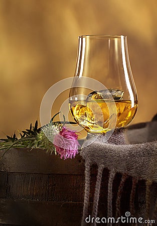 Glass of Scotch Whisky and Scottish Thistle Stock Photo