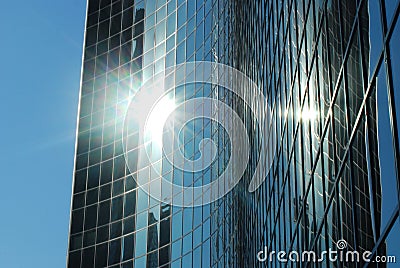 A glass skyscraper with the sun glistening Stock Photo