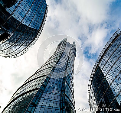 Glass skyscrapers of irregular shape. Bottom view. Abstract architectural detail of corporate building suitable as Stock Photo