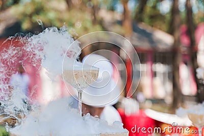 Glass is smoking in the head of pyramid of champagne close up. Beginning of wedding ceremony, Stock Photo