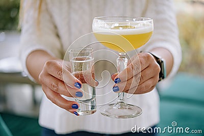 Glass of star martini in the hands of a girl Stock Photo