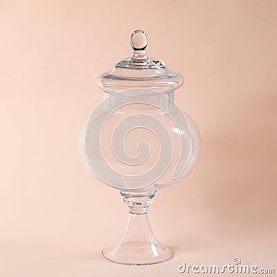 Glass sweets jar on a beige background Stock Photo